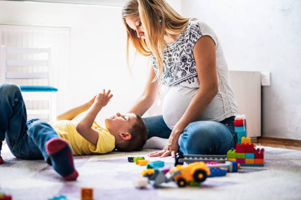 istock Playful pregnant mother and son 1254390163