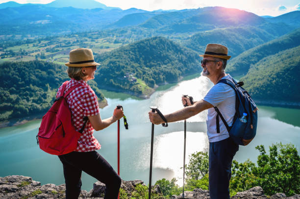 istock Hikers stands on a mountain top and admires view 1254392104