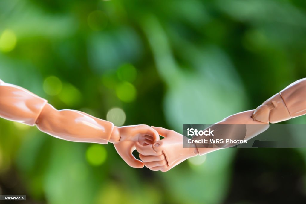Two Action Figures Holding Hands Two Action Figures Holding Hands Outside - Arms and Hands Only Action Figure Stock Photo