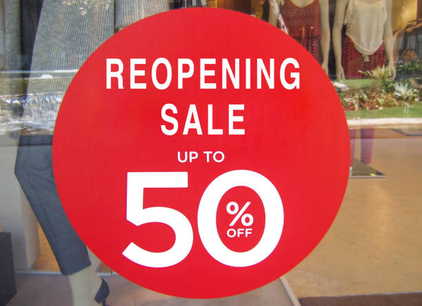 Shot of a reopening store sale sign at store window, post Covid 19 pandemic