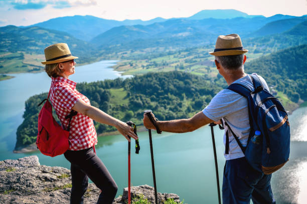 istock Hikers stands on a mountain top and admires view 1254393900