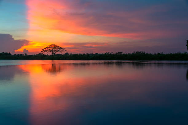 istock Reflection in Water of Lake Against Sky During Sunset 1254394017