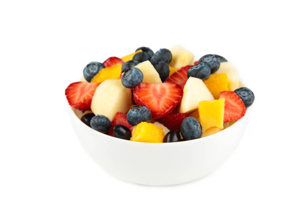 istock Fresh fruit salad in white bowl isolated on white background 1254395485