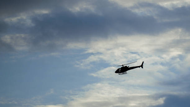 istock Helicopter flying trough clouds in the sky 1254395644