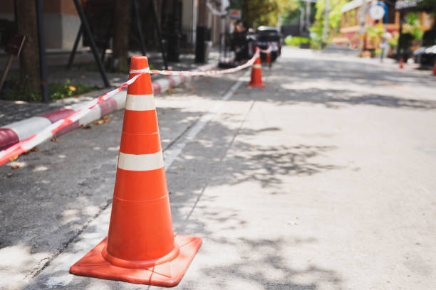 istock White orange traffic hazard cone on asphalt road repair 1254396629