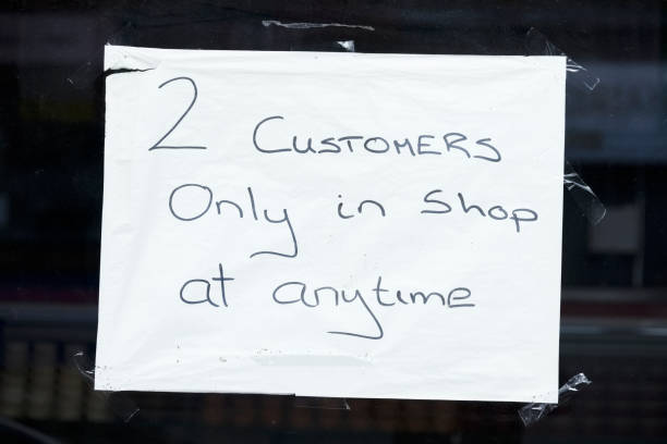 istock 2 customers allowed in shop at anytime due to covid-19 1254397066