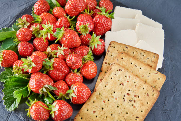 istock Sandwiches with fresh berries on a dark background, top view 1254398342