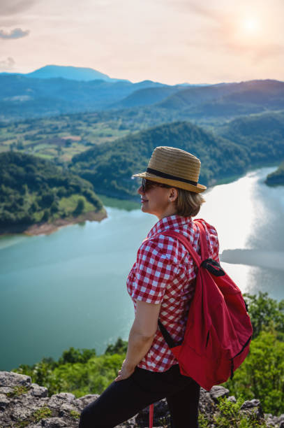 istock Hiker stands on a mountain top and admires view 1254398553