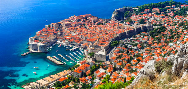 Splendid Dubrovnik town - pearl of Adriatic coast. Aerial view of old fortified town. Landmarks of Croatia Splendid Dubrovnik town - pearl of Adriatic coast. Aerial view of old fortified town. Landmarks of Croatia gondola traditional boat photos stock pictures, royalty-free photos & images
