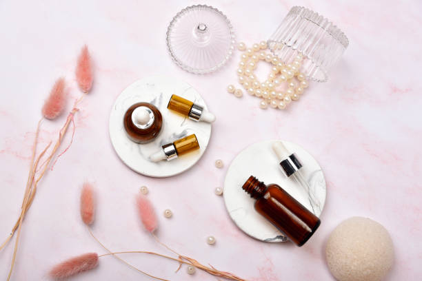 istock Cosmetic bottle containers on pink marble background, Blank label package for branding mock-up, Natural organic beauty product concept, Research and development of purified skincare. 1254400404