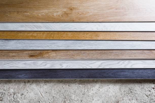 istock laminate flooring planks variations on concrete floor 1254400449