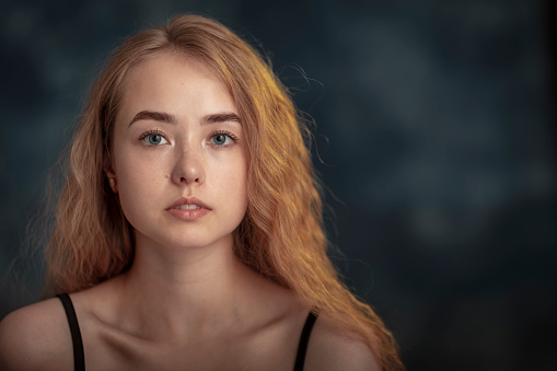 Portrait of young beautiful female model with almost no makeup