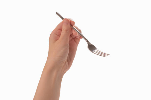 istock Fork in woman hand isolated on white. 1254400796