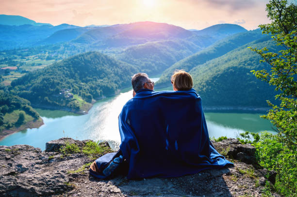 istock Hikers sit on a mountain top and admires view 1254402421