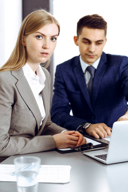 istock Business people using laptop pc while discussing project in office. Successful meeting and negotiation concepts 1254408207