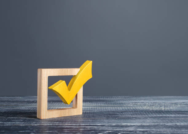 yellow voting tick in a checkbox. democratic institutions, vote on democratic elections, referendum. opinion poll. make right choice. confirmation, passing the test. verification. law implementation - checkbox check mark questionnaire checklist imagens e fotografias de stock