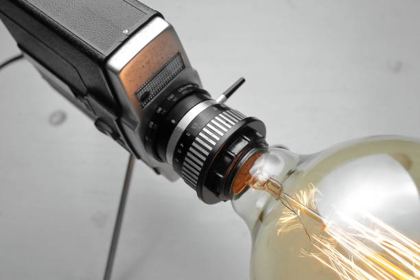 istock Retro lamp from an old camera with an Edison lamp on a gray background. Concept is a good idea. 1254408597