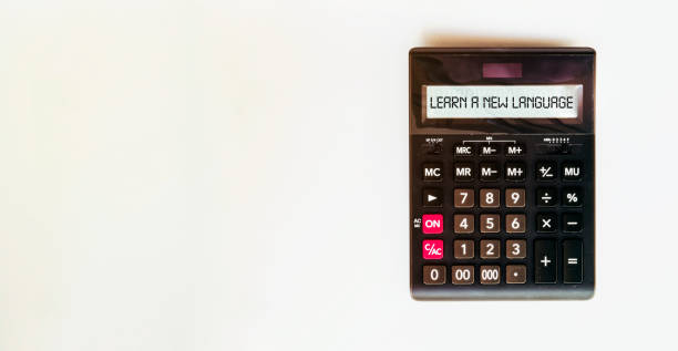istock black calculator with text LEARN A NEW LANGUAGE on the white background 1254409536