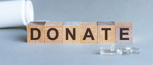 istock Donate text on a wooden background. Concept medicine. 1254411498