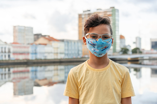 People with N95 respiratory mask in front of the Capibaribe river in Recife, Pernambuco state.