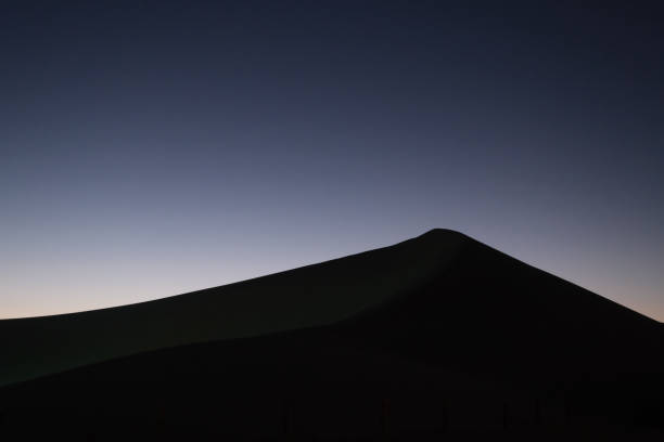 istock beautiful night scene of one sand dune. simplicity 1254414588