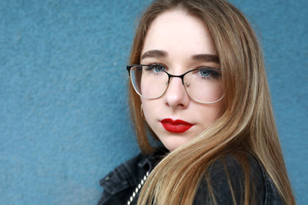 istock Girl on blue cement wall background 1254414989