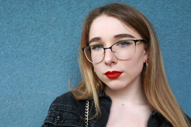 istock Teen on blue cement wall background 1254414990