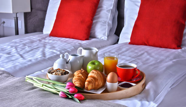 istock Breakfast on tray in bed in hotel room 1254416235