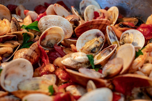 Close up shot of fresh sauteed clams with garlic and butter sauce