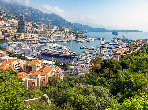 Monaco, France - August 2, 2022: Panoramic view of medieval castle and stronghold in Monaco Ville royal old town district over Hercules Port at Mediterranean Sea coast