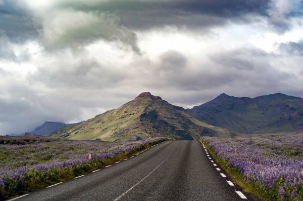 istock A road with colorful mountains and impressive clouds in the background 1254418014