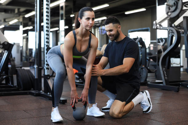 istock Fitness instructor exercising with his client at the gym. 1254418615