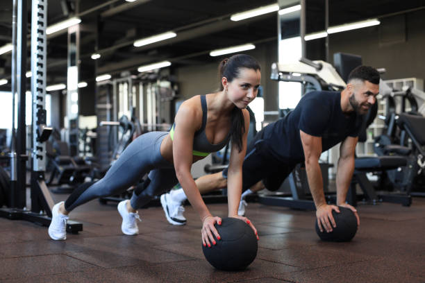 beautiful young sports couple is working out with medicine ball in gym. - 16019 imagens e fotografias de stock