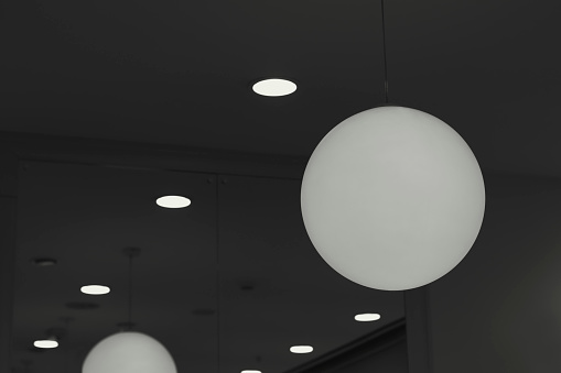 Large white lamps in a dressing room of a clothing store. The interior of shopping centers.