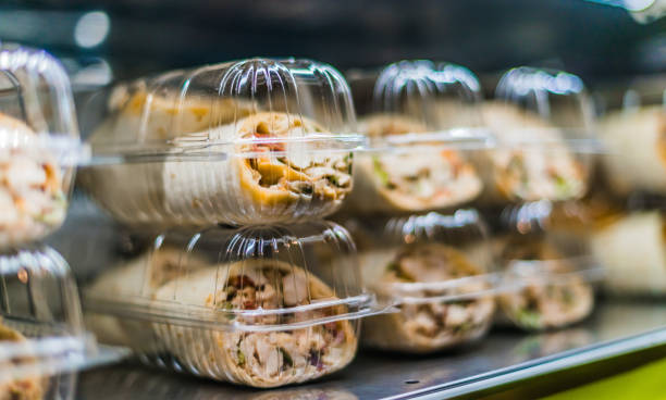 Pre-packaged sandwiches displayed in a commercial refrigerator