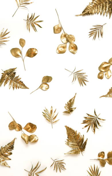 istock Gold leaves pattern isolated on a white background. top view.copy space.abstract. 1254421171