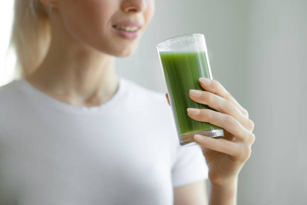 istock Drinking green superfood smoothie 1254424479