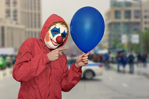 Mr Clown. Portrait of Funny face Clown man in colorful uniform standing holding copy space. Happy expression male bozo in various pose with frame mockup blank space on isolated background.