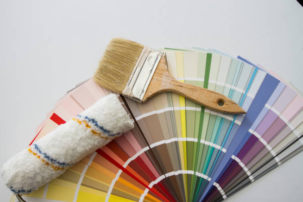 istock Old Brush And Paint Roller On The Color Chart 1254425569