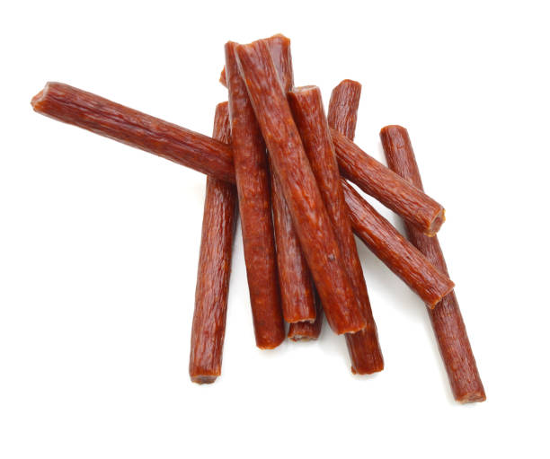 istock Smoked thin sausages, isolated on white 1254428323