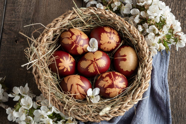 istock Easter eggs dyed with onion peels with a pattern of fresh herbs 1254428791