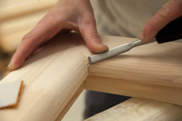 carpenter sanding wooden window stock photo