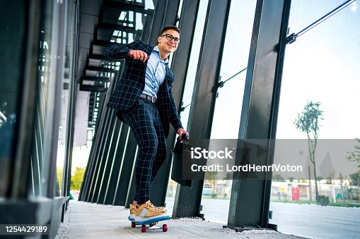 istock Young businessman on skateboard 1254429189
