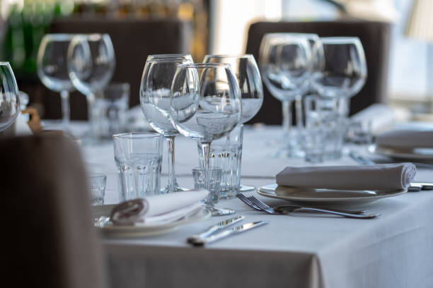 istock Empty glasses in restaurant background. Table set for an event party or wedding reception. 1254431933