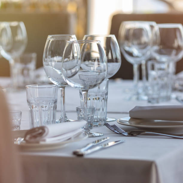 istock Empty glasses in restaurant background. Table set for an event party or wedding reception. 1254431944