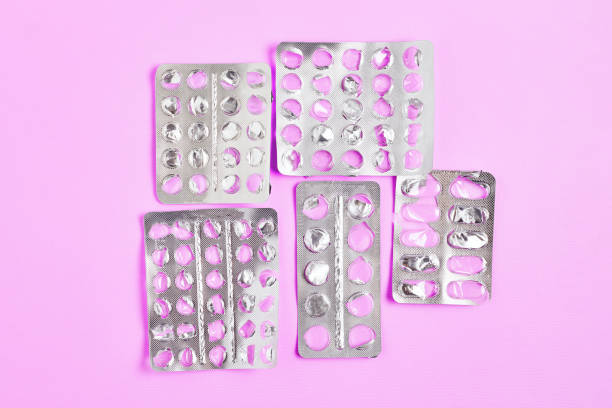 istock empty blister packs of pills with one partially full pack on pink background. flat lay simple composition, top view 1254431990