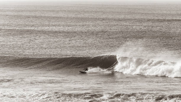 istock Surfer Surfing Ocean Wave  Sepia Vintage Panoramic 1254436363
