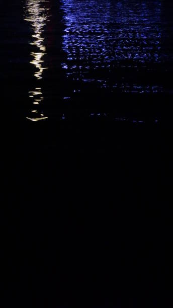 istock Blue and white reflection on sea at night, background 1254436727