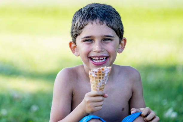 istock 6 year old hispanic boy enjoying ice cream 1254438884