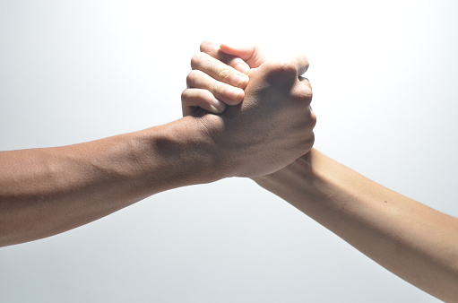 Friendly handshake, friends greeting, teamwork, friendship on isolated white bcakground